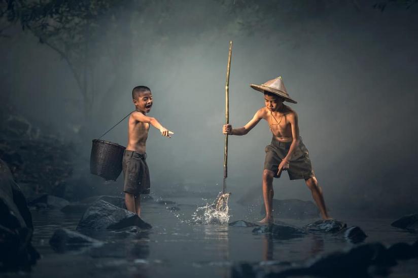 niños pescando en el rio